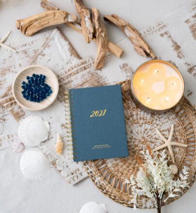 Val Marie Paper 2027 Rhythms prayer journal in Dusk, a deep slate blue with gold spiral binding and gold foil lettering